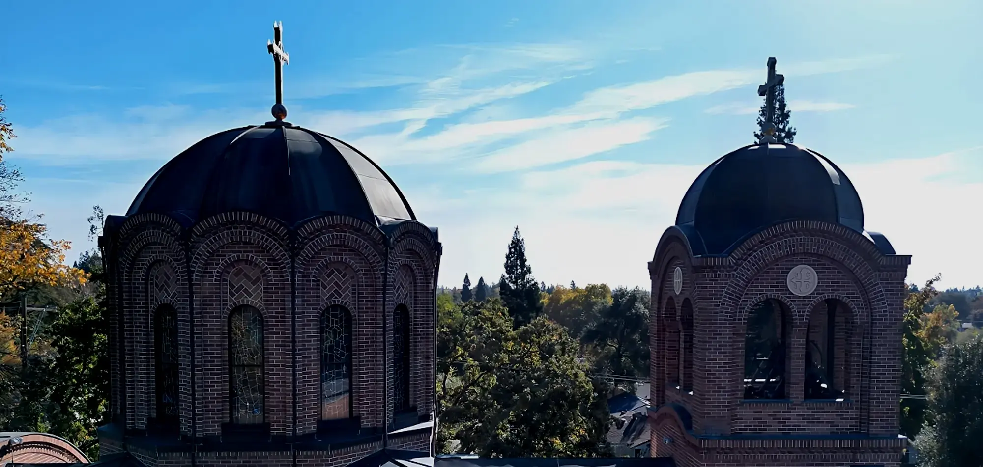Twin domed church towers against a clear blue sky