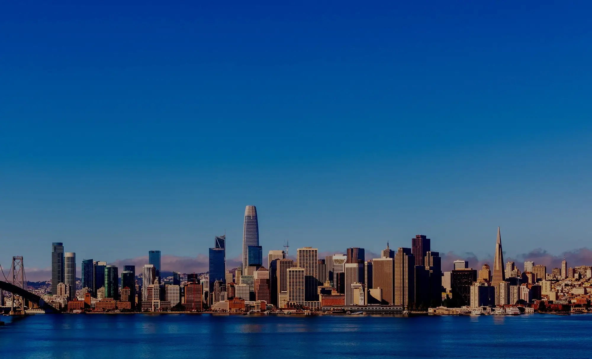 San Francisco skyline across the bay at dusk