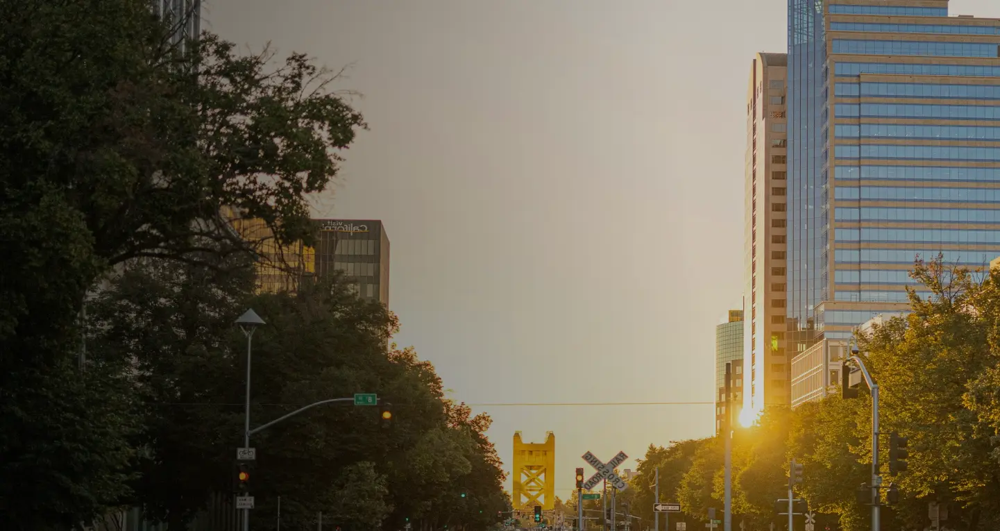 Tower Bridge at the end of a downtown street at sunset
