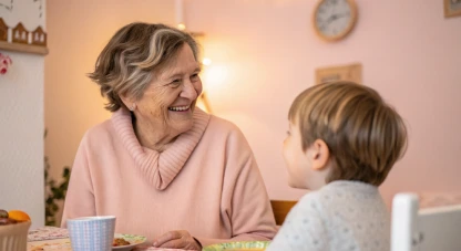 Grandmother smiling at her grandson over a kitchen table